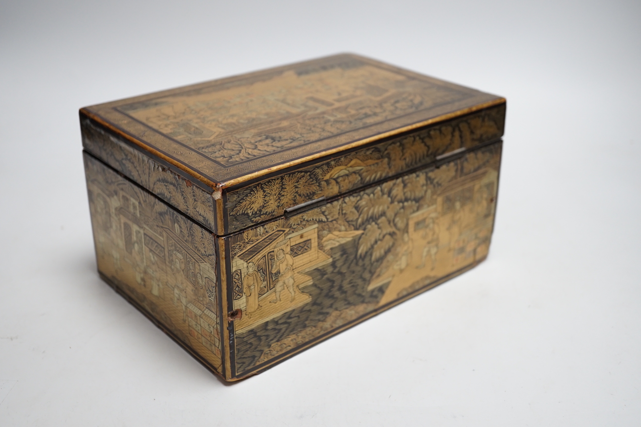 A 19th century Chinese export lacquer tea caddy, black ground with gilt decoration, containing a separate lidded pewter lining box with engraved decoration, 23cm x 16cm x 12cm